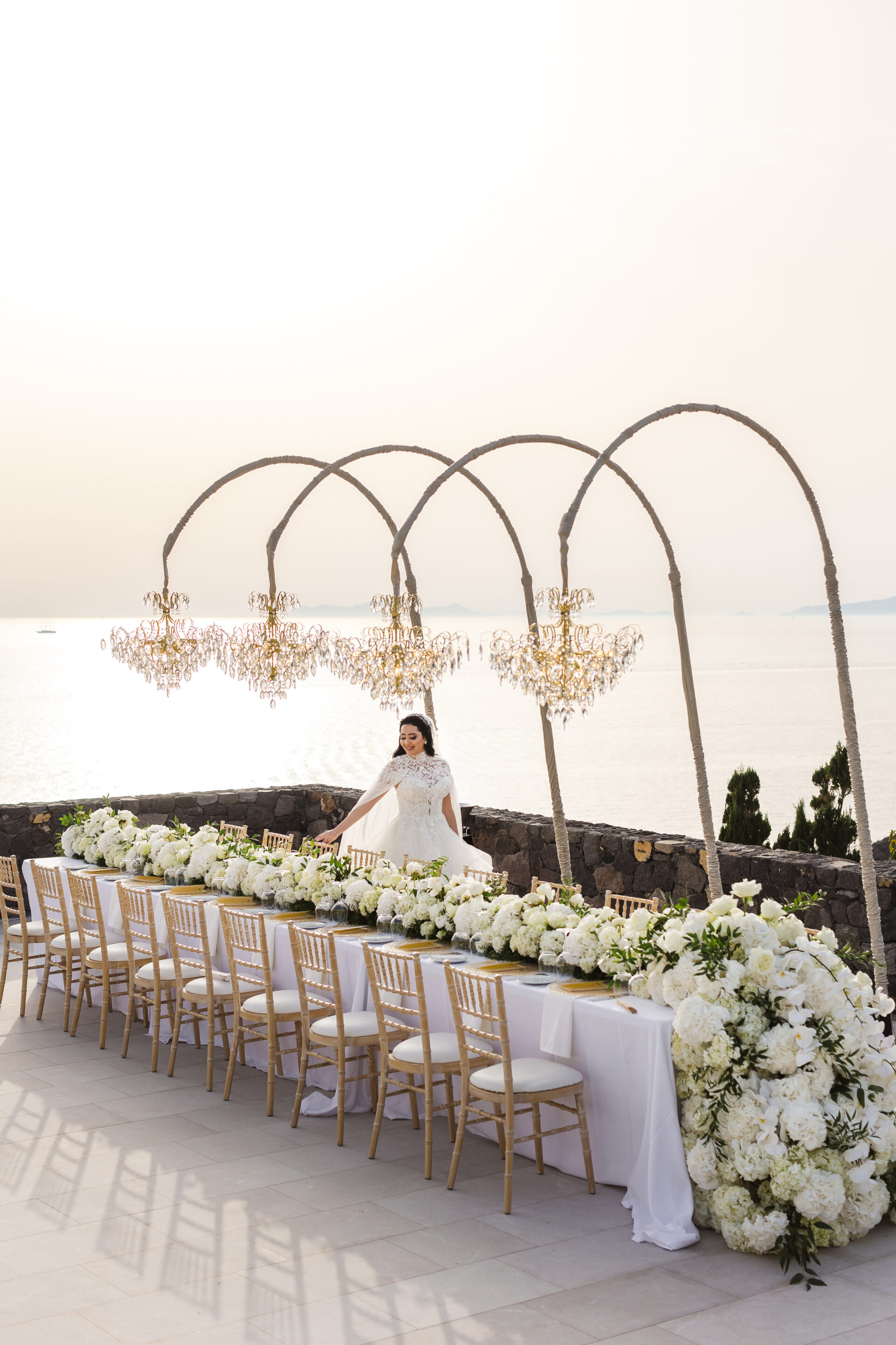 Santorini wedding reception with bride and floral setup by Santorini photographer