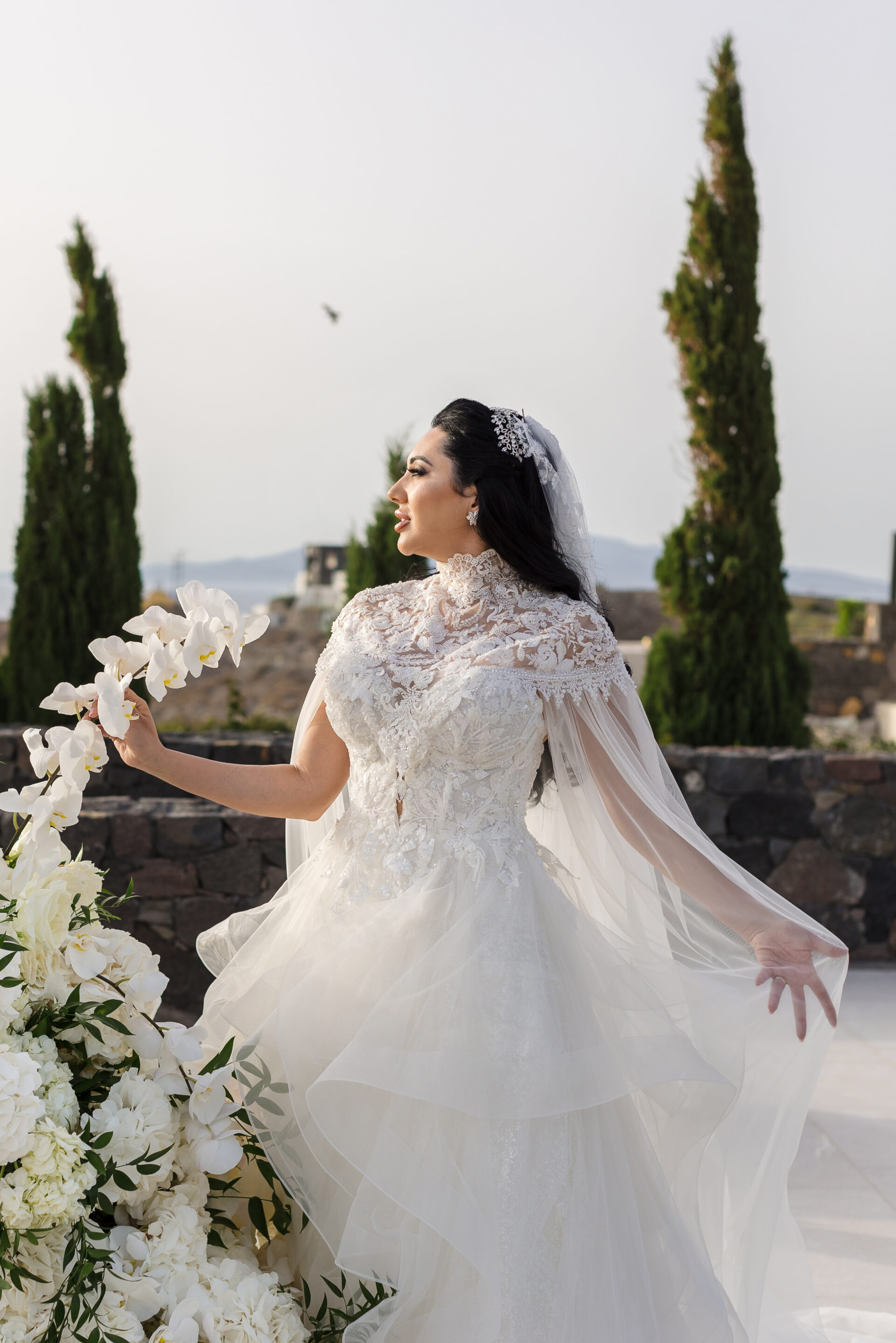 Bride at Santorini wedding reception table by Santorini photographer