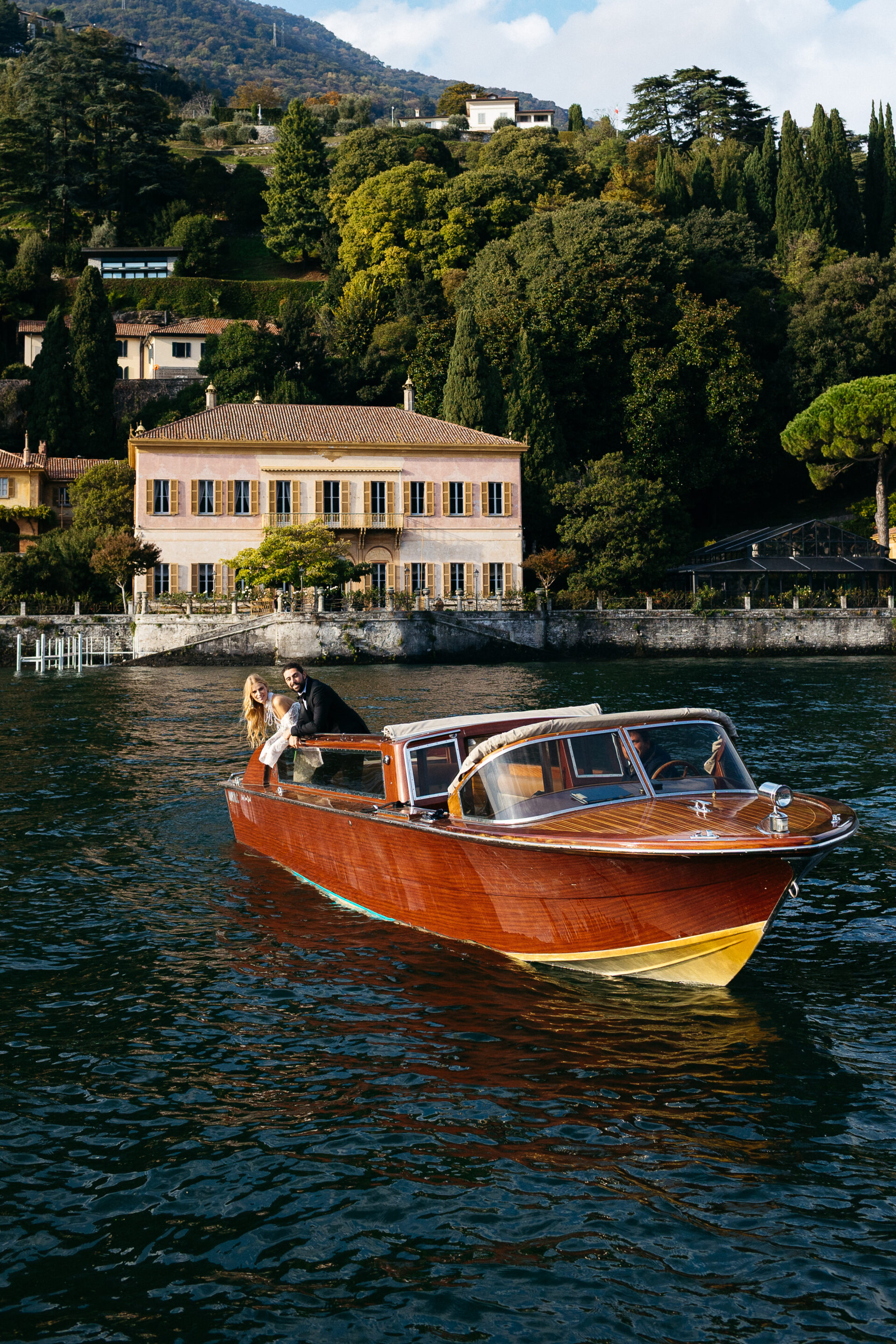 Couple on wooden boat in Lake Como captured by Santorini photographer