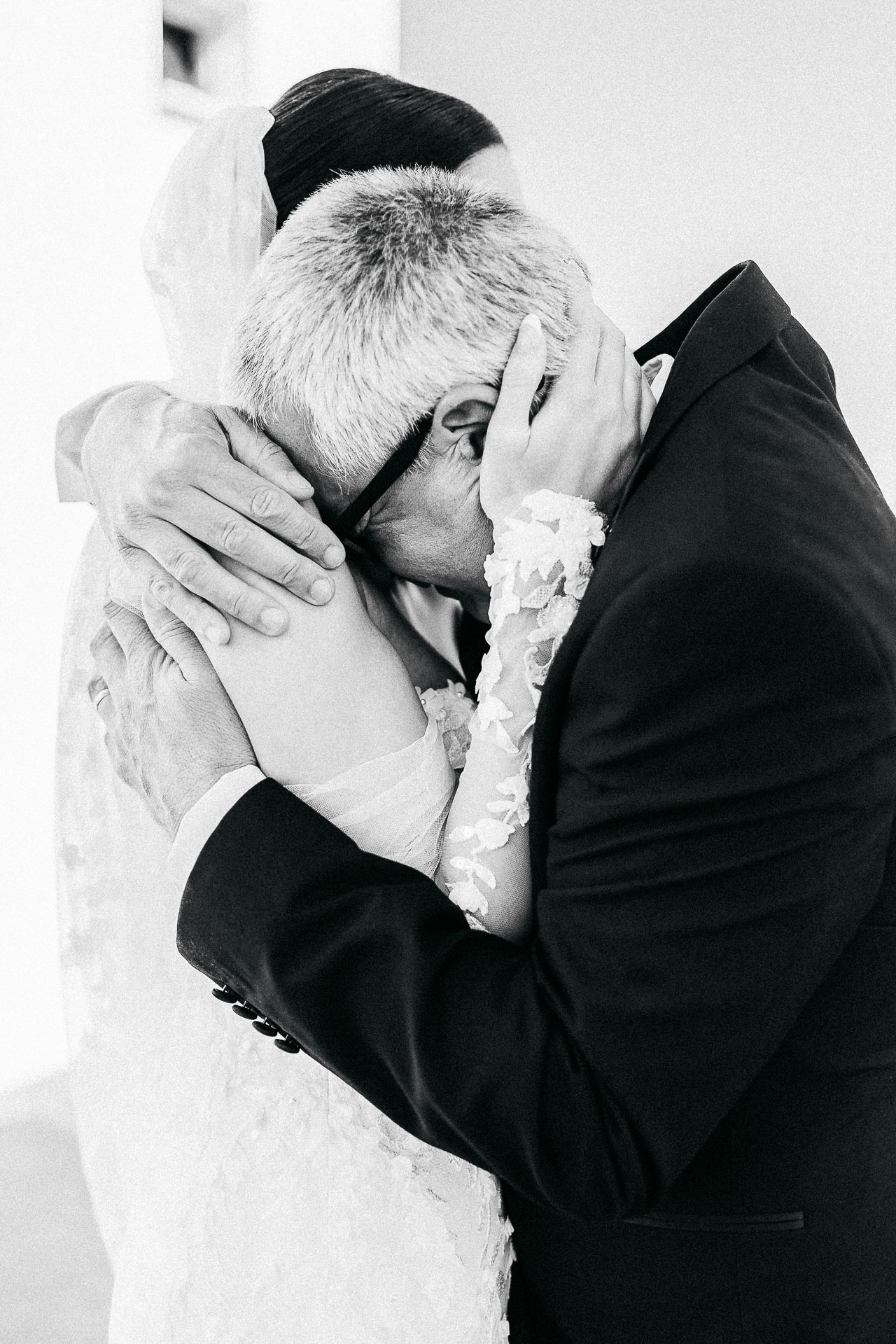 Santorini wedding photographer captures emotional embrace between bride and her father