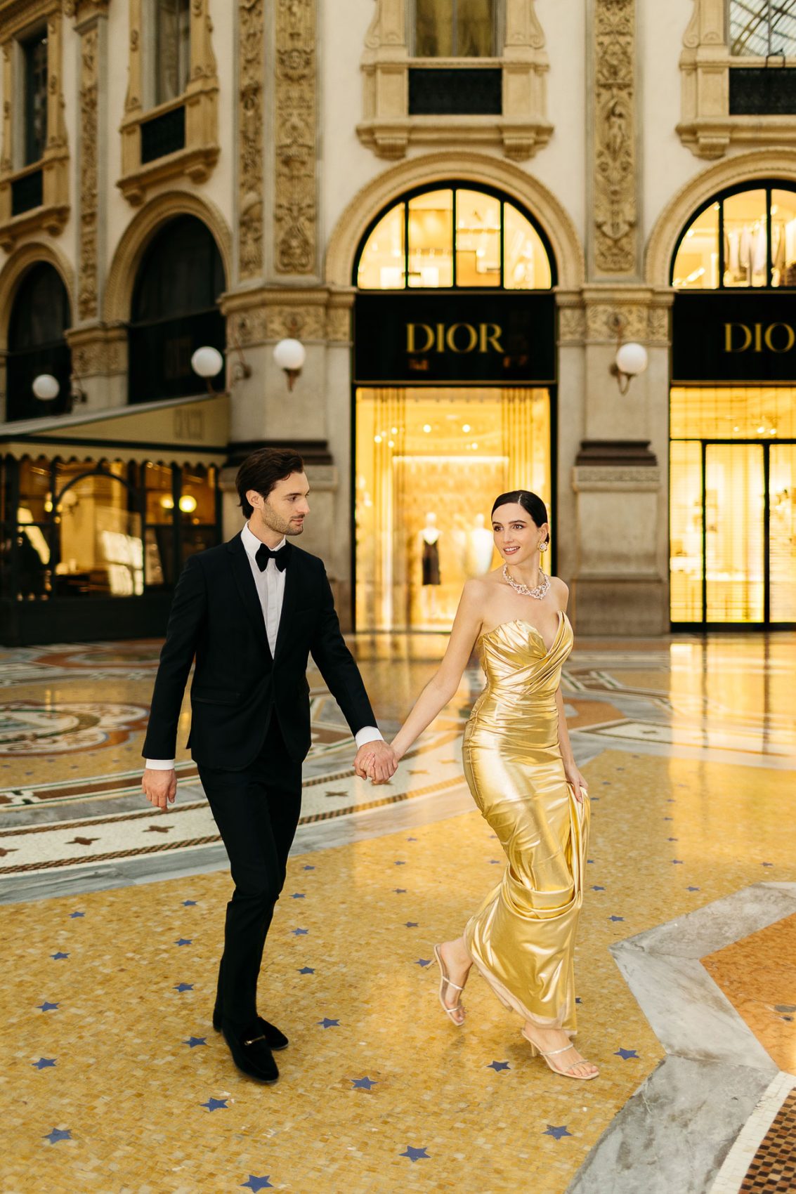 santorini wedding photographer couple walking in designer galleria