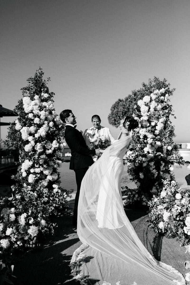 Santorini wedding photographer captures couple laughing during ceremony