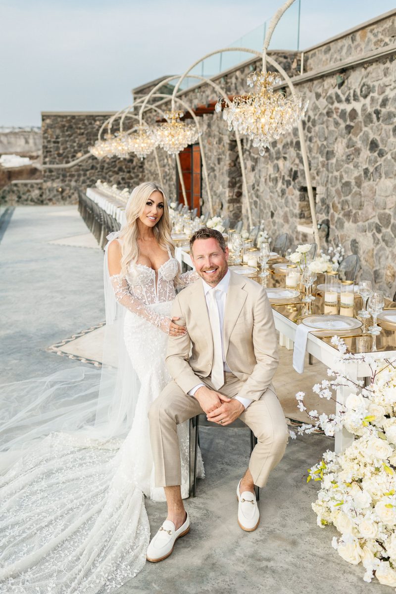 Santorini wedding photographer captures bride and groom at their elegant outdoor reception.