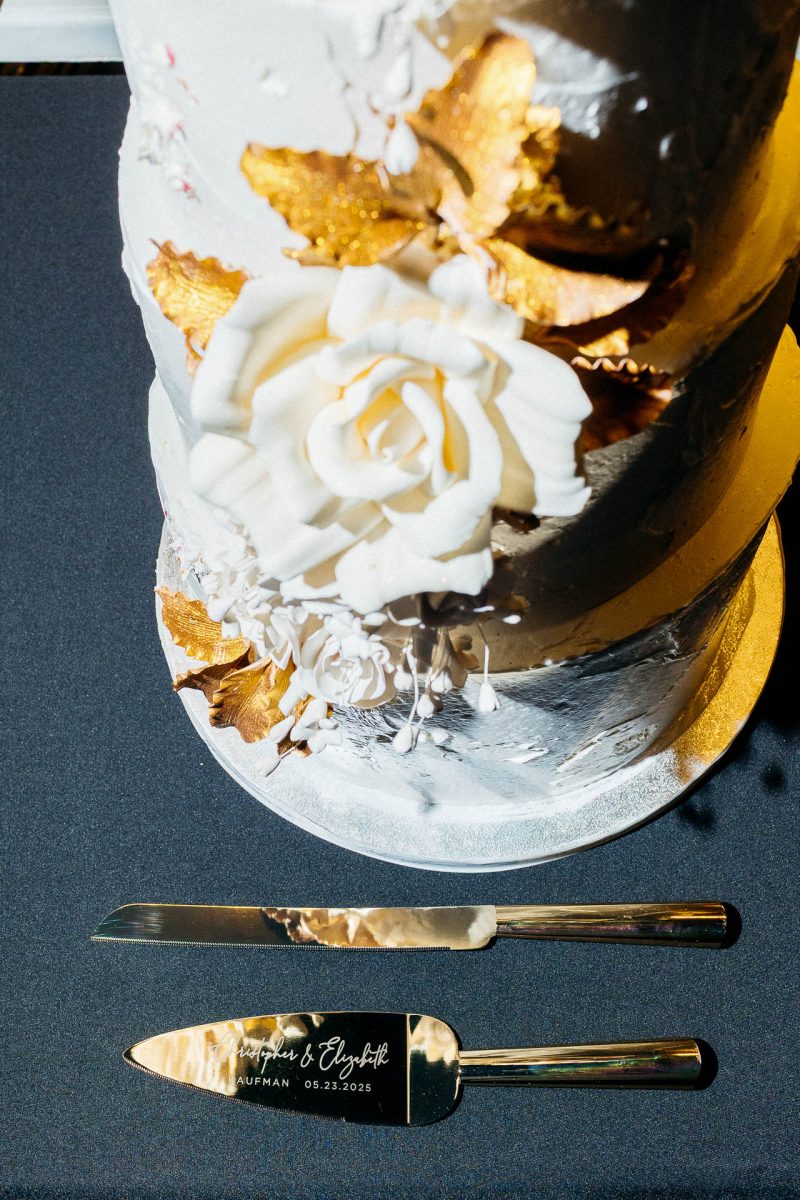 Santorini wedding photographer captures elegant wedding cake with gold accents.