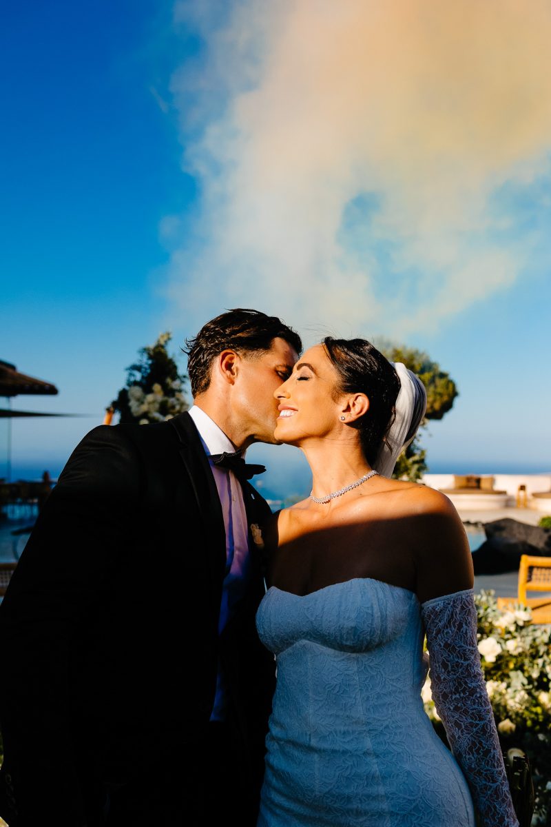 Santorini wedding photographer captures groom kissing bride