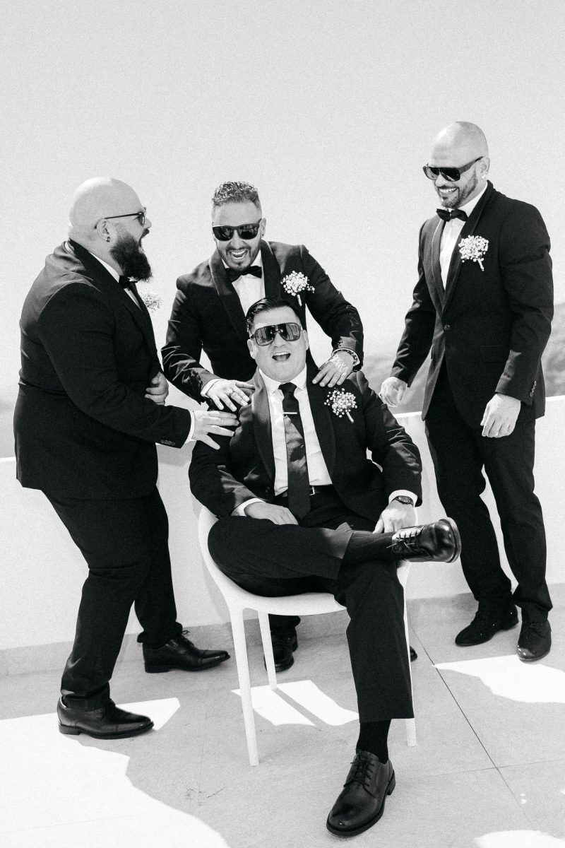 Groom and groomsmen laughing – Santorini wedding photographer