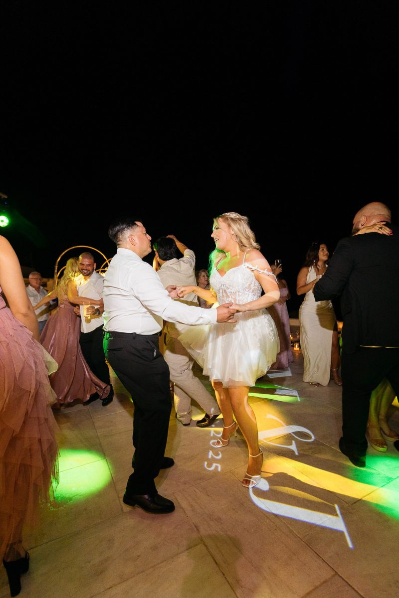 Bride dancing at Santorini wedding reception by Santorini wedding photographer