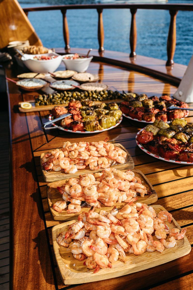 Greek wedding catering on a boat in Santorini, captured by a Santorini wedding photographer