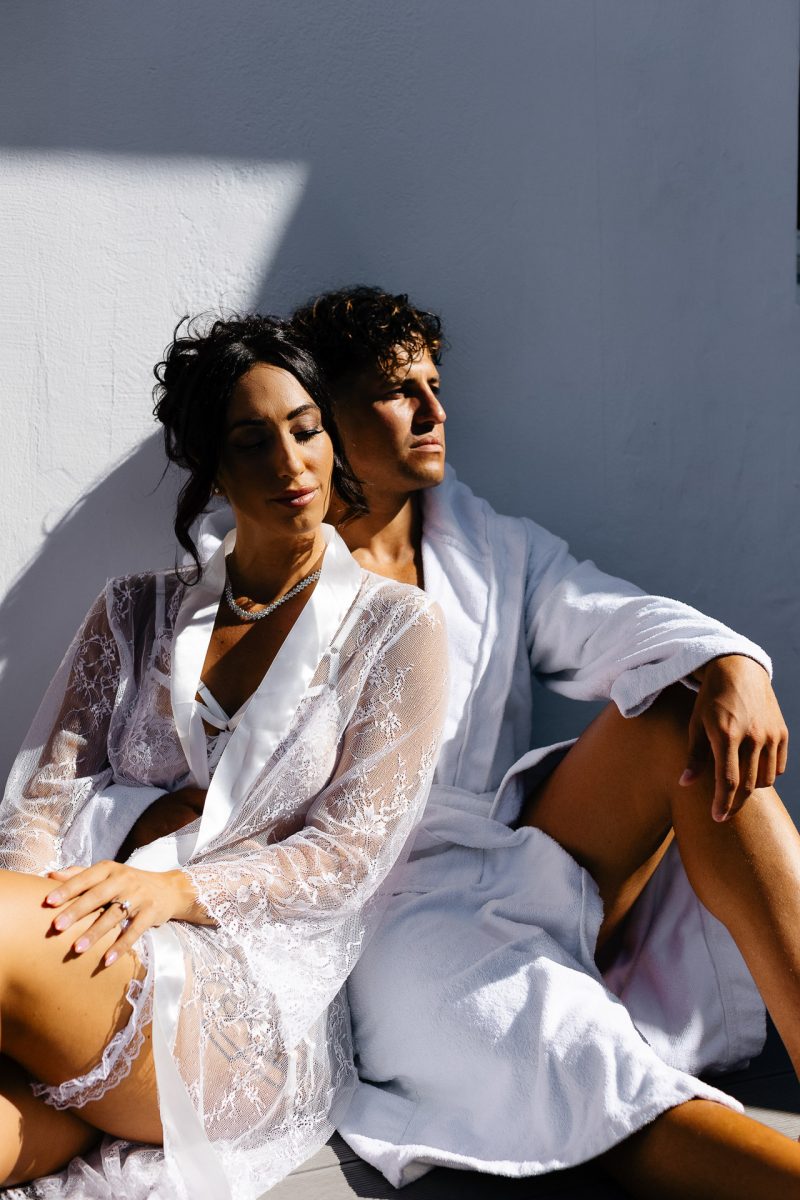 Santorini couple in robes sharing a quiet wedding morning moment