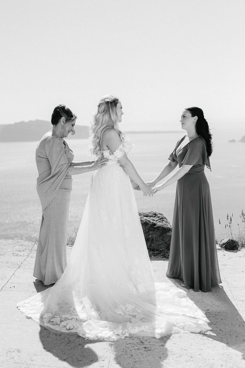 Bride with mom and sister before ceremony — Santorini wedding photographer
