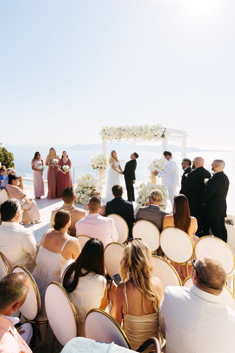 Santorini wedding photographer captures emotional ceremony by the sea